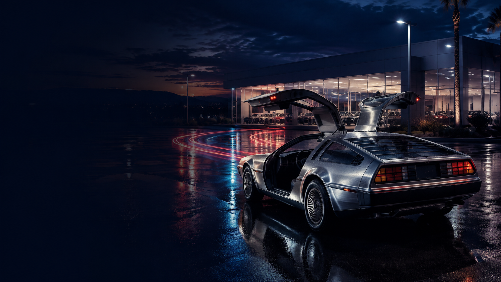 A stainless-steel gull-wing sports car outside a dealership at night